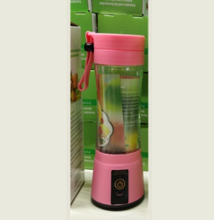 Pink portable blender with a green box in the background