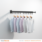 HOORIVA black wall-mounted retractable clothes drying rack with shirts hanging